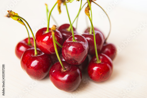 Ripe cherries on wooden surface © leledaniele