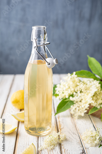 Delicious healthy refreshing beverage, sweet elderflower syrup or cordial in a glass bottle