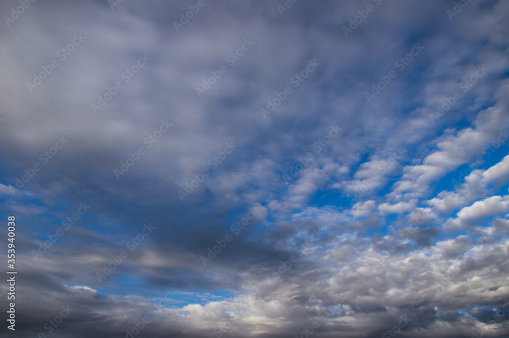 Blue sky, high, majestic Cumulus clouds, the Sun.