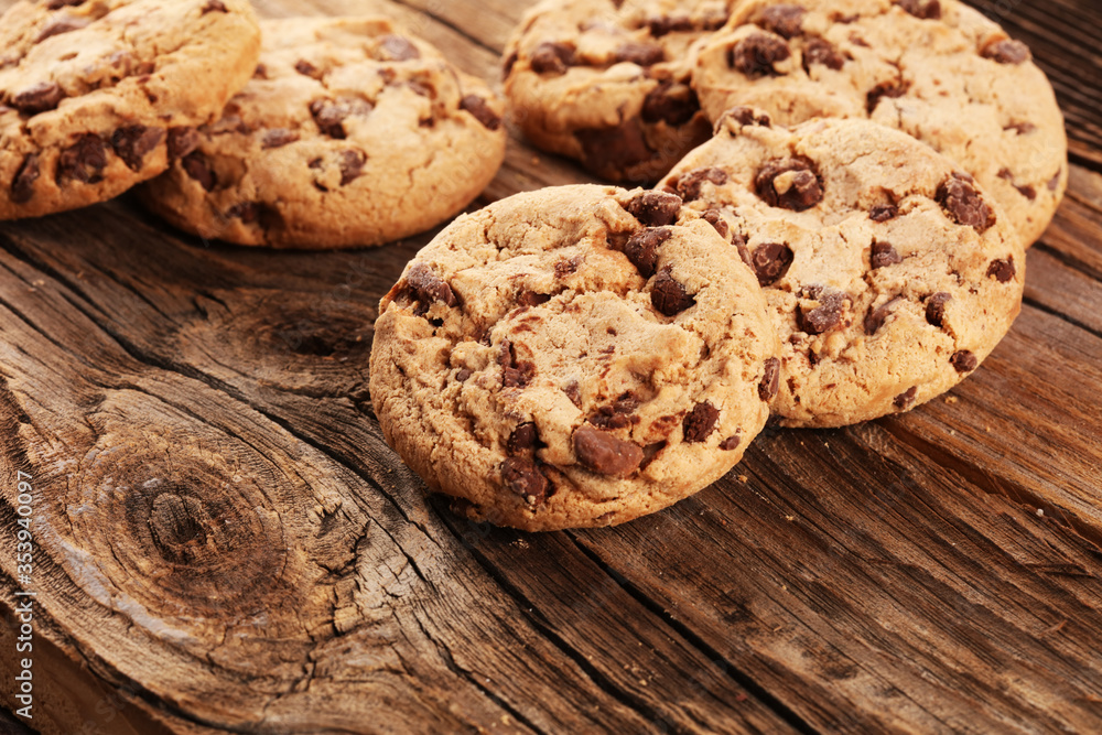 Chocolate cookies on wooden table. Chocolate chip cookies shot on vintage background Chocolate cookies on wooden table. Chocolate chip cookies shot on vintage background