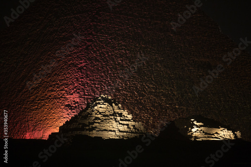 The lighted great Pyramid and the Pyramids  of Queen Henutsen and  Queen Meritetis. photo