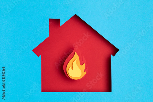 Papercut house with fire inside. Home insurance, security, safety, damage, accident prevention