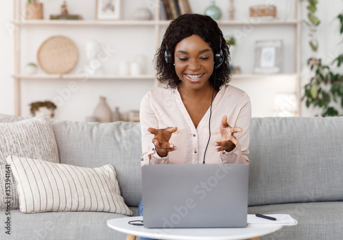 Online Tutoring Concept. Smiling black female tutor having video call with student