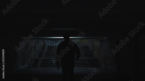 man walks in the evening city underpass