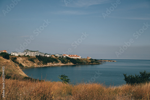 Fototapeta Naklejka Na Ścianę i Meble -  sea shore beach coast and sunny city at the skyline 