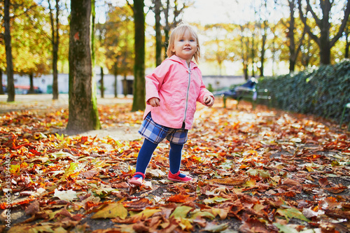 Adorable cheerful toddler girl running in Tuileries garden in Paris © Ekaterina Pokrovsky