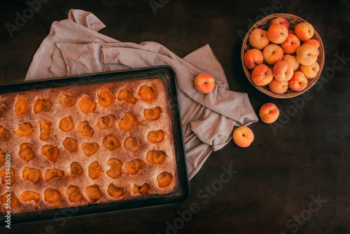 Traditional Majorcan apricot cake on rustic wooden table, flat lay. Delicious vegan homemade recipe