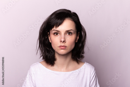 pretty woman in white t-shirt on gray background