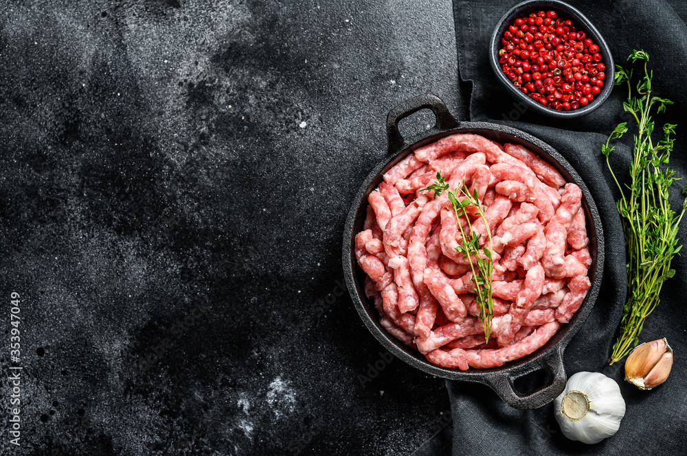 Raw ground pork. Organic minced meat, forcemeat. Black background. Top view. Copy space