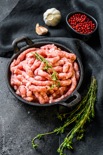 Raw chicken, Turkey ground meat in a pan. Organic forcemeat, mince. Black background. Top view