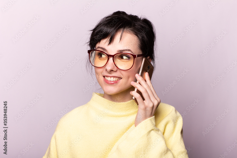 beautiful girl in yellow sweater glasses speaks on the phone beautiful girl in yellow sweater glasses speaks on the phone
