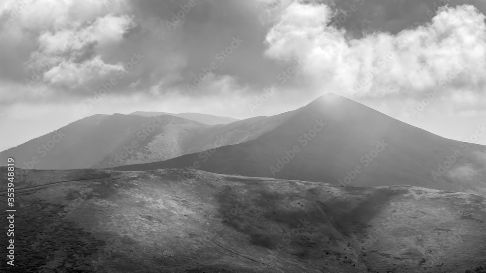 Black and white view from Silver head summit on Serbian and Bulgarian border on Kom summit in Bulgaria with dramatic clouds in the sky