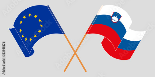 Crossed and waving flags of Slovenia and the EU