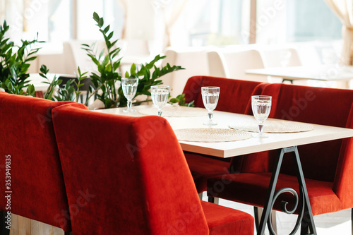 Red interior  in an empty cafe during pandemic. No guests. Served table.