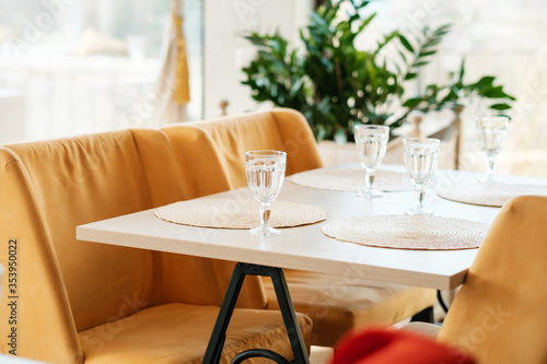 Empty wine glasses in an empty cafe during pandemic. No guests. Served table.