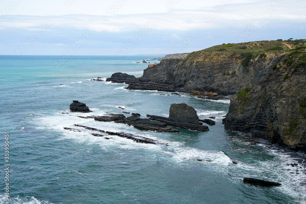 rocky cliff at typical beach at the west coast of Portugal rocky cliff at typical beach at the west coast of Portugal