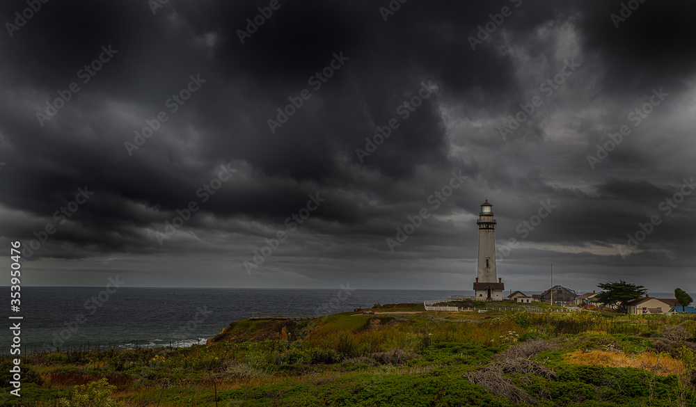 Pigeon Point Lighthouse with a very ominous dark cloud coming in from the Pacific ocean
