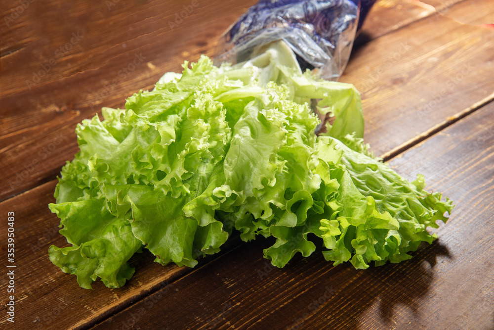 Fresh leaves of salad on brown table ( Fresh leaves of salad on brown table (
