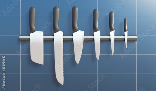 Group of kitchen knives on a magnetic stand in the kitchen