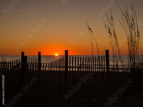 Sunset with Fence on Beach on Atlantic Coast, South Carolina, USA
