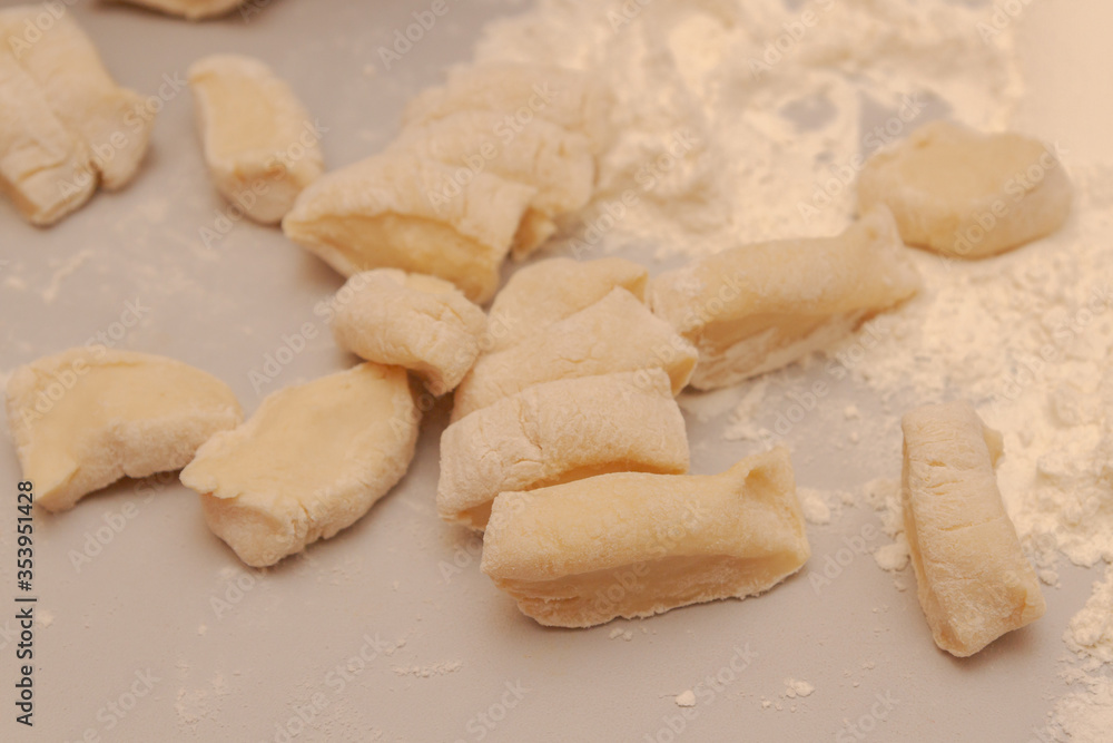Sliced raw dough into pieces prepared for cooking homemade dumplings