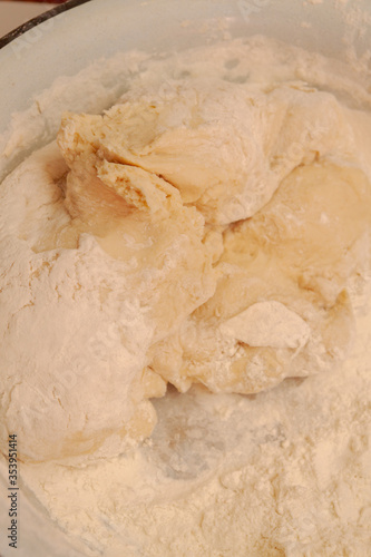 Raw dough mixed in a bowl for making homemade dumplings