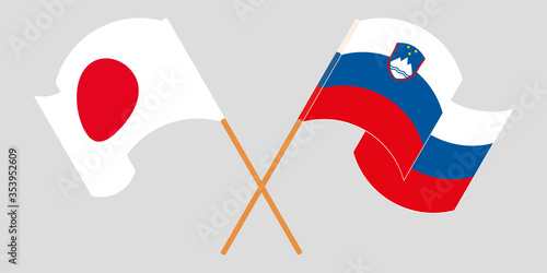 Crossed and waving flags of Slovenia and Japan