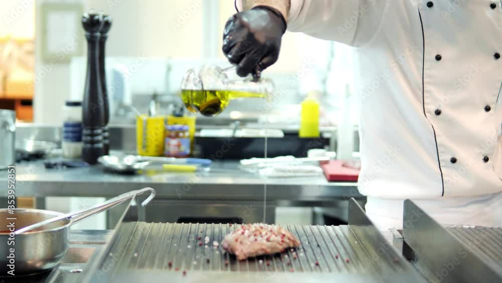 Chefs in protective masks and gloves prepare food in the kitchen of a restaurant or hotel Chefs in protective masks and gloves prepare food in the kitchen of a restaurant or hotel