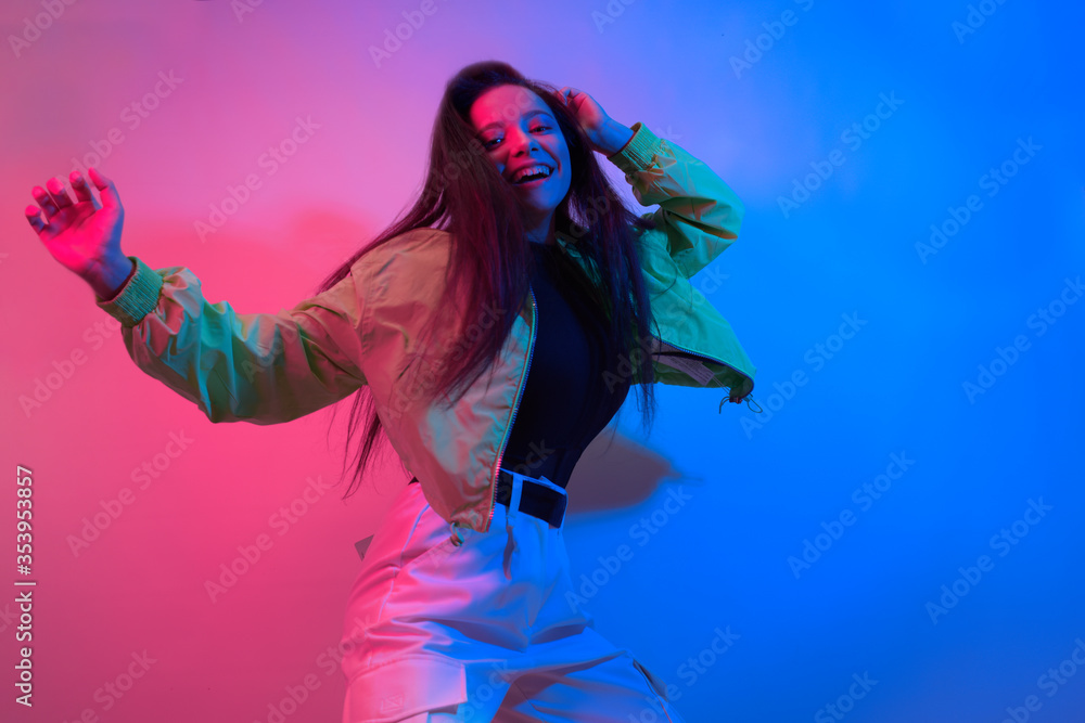 The brunette dances in neon, the dancer in red-blue. Hip hop girl, party, smile. The brunette dances in neon, the dancer in red-blue. Hip hop girl, party, smile.