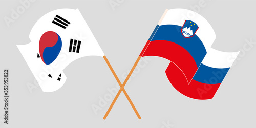 Crossed and waving flags of Slovenia and South Korea