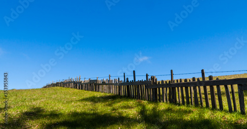 Old Wooden Fence Reaching Across Green Pasture on Marshall-Petaluma Road Near Marshall,California,USA