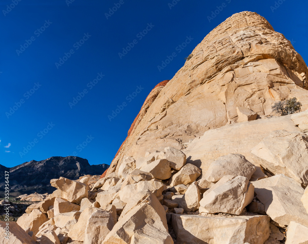 Large Boulders and The Aztec Sandstone Slickrock of The Calico Hills Near The Sandstone Quarry With Turtlehead Peak in the Distance,  Red Rock Canyon NCA, Las Vegas, USA