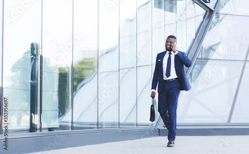 Entrepreneur Talking On Cellphone On The Way To Work Indoors