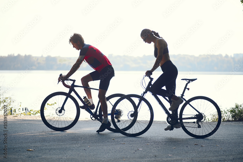 Fototapeta premium People with a bikes. Couple in a forest. Morning bike ride.