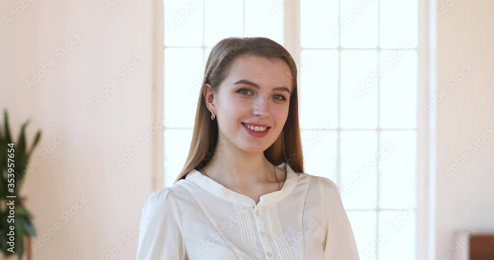 Head shot close up smiling pretty young woman looking at camera. Happy female patient satisfied with medical services. Portrait of attractive businesswoman or client standing alone in office. Head shot close up smiling pretty young woman looking at camera. Happy female patient satisfied with medical services. Portrait of attractive businesswoman or client standing alone in office.