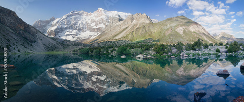 Tourism in Tajikistan  lake in the Fan Mountains  panorama nature. Beautiful reflection in the water of snow-capped peaks. Travels in Central Asia.