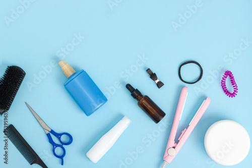 Hairdresser tools on blue background with copy space