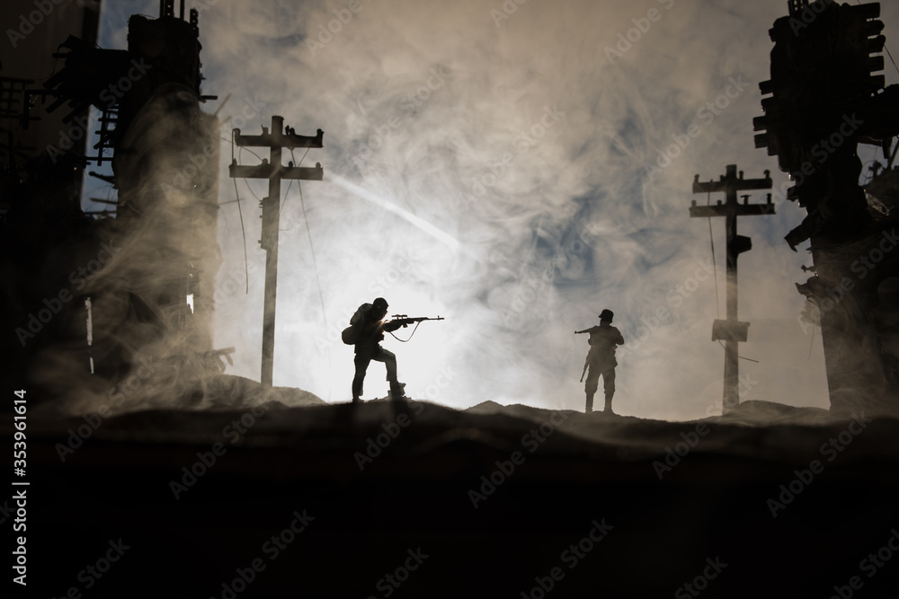 Army sniper with large caliber rifle standing in the fire and smoke. War Concept. Battle scene on war fog sky background, Fighting silhouettes Below Cloudy Skyline at night. City destroyed by war