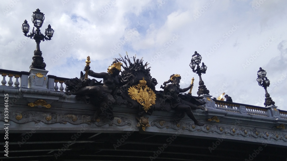 Statues on bridge over Seine river