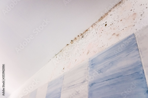 Ugly moisture stains on the white ceiling of a wall