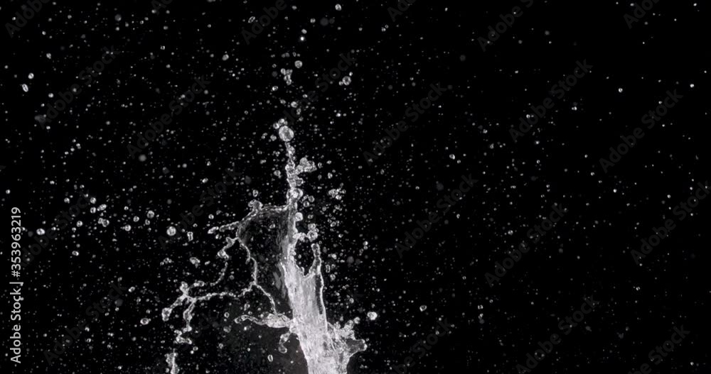 water rising up from the center of a black background.