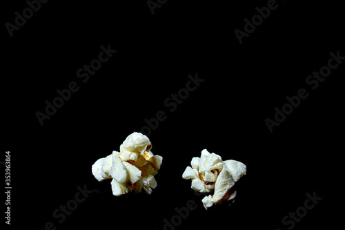 two popcorn on black background