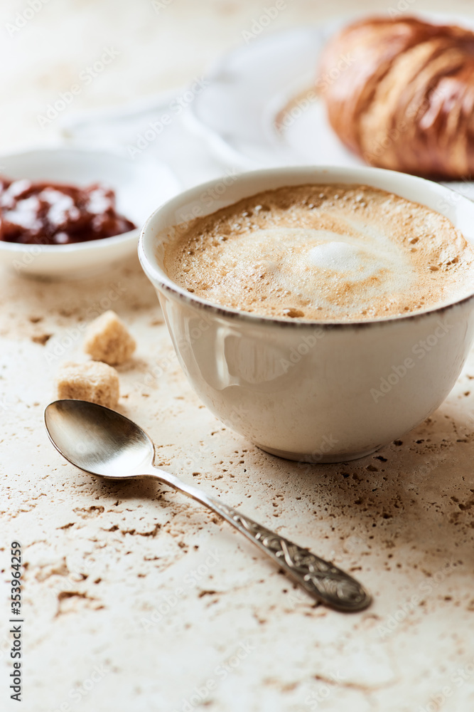 Coffee with milk on bright stone background. Close up. Coffee with milk on bright stone background. Close up.