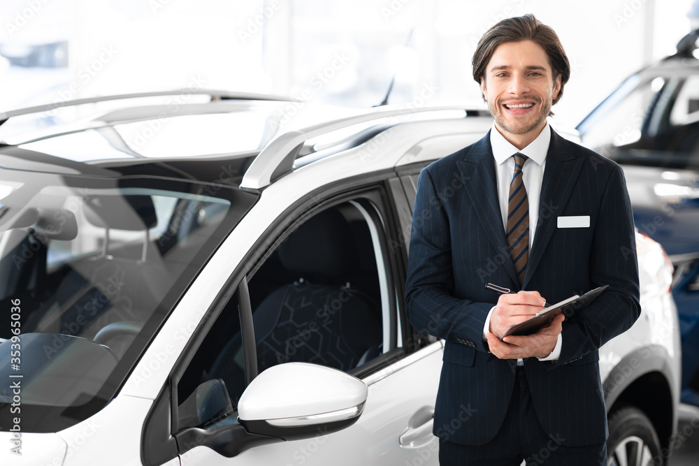 Salesman Selling Car Posing In Dealership Center Salesman Selling Car Posing In Dealership Center