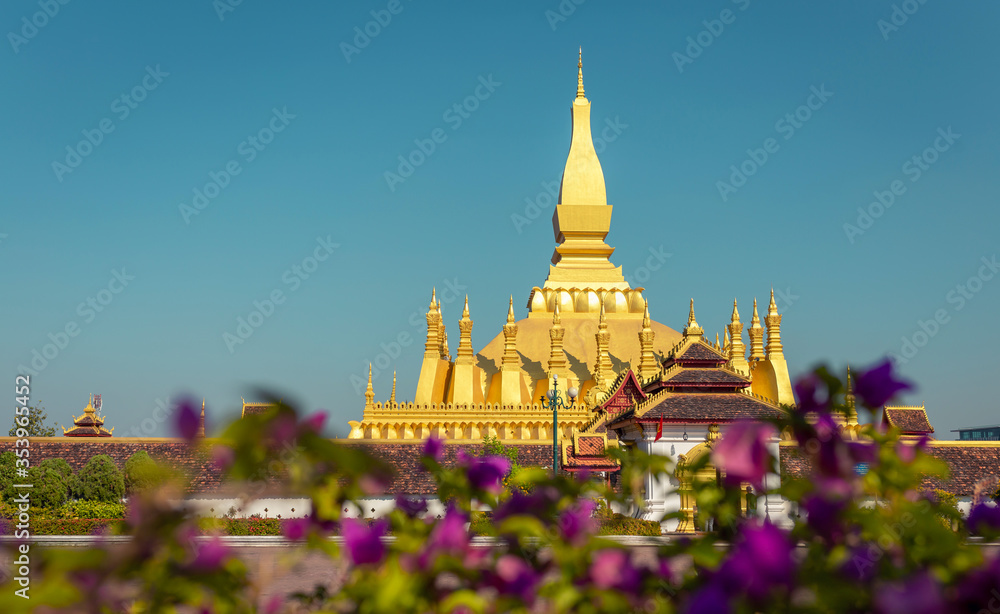 Naklejka premium Golden Pagoda in Vientiane, Laos. Pha That Luang at Vientiane. Blue sky background beautiful.