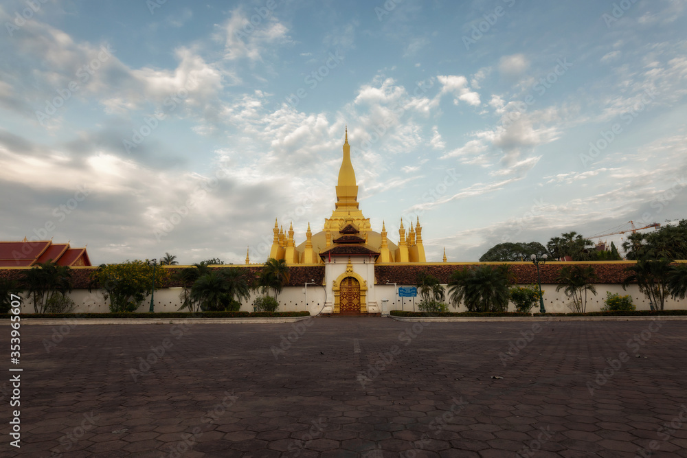 Fototapeta premium Golden Pagoda in Vientiane, Laos. Pha That Luang at Vientiane. Blue sky background beautiful.