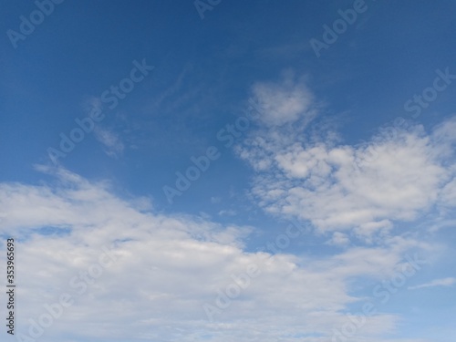 white clouds against a blue sky background