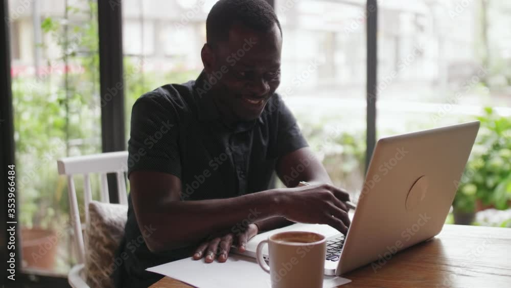 Close up of happy African man video chatting online with laptop Black man making video call with his family concepts of people stay home keep contact with each other through internet Close up of happy African man video chatting online with laptop Black man making video call with his family concepts of people stay home keep contact with each other through internet