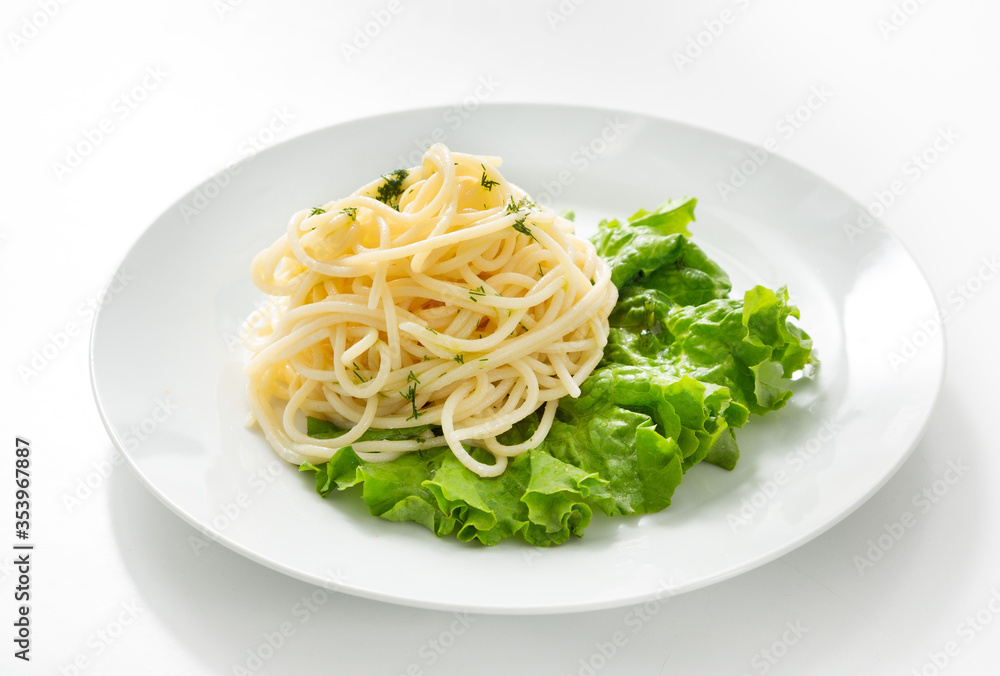 Noodles, italian pasta on lettuce in a plate on the table. Isolate
Noodles, italian pasta on lettuce in a plate on the table. Isolate