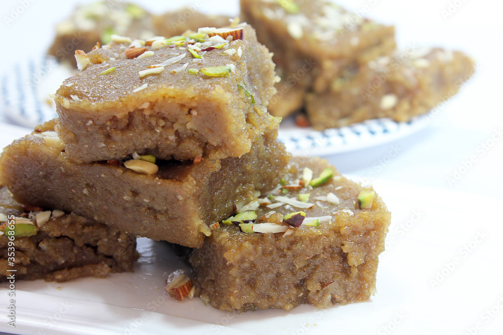 Indian Traditional sweet Lapsior shira or Halwa made from broken wheat,jaggery and desi gheeand garnished with nuts.selective focus. Indian Traditional sweet Lapsior shira or Halwa made from broken wheat,jaggery and desi gheeand garnished with nuts.selective focus.